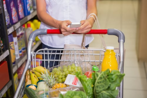 woman buy products and texting at supermarket-1